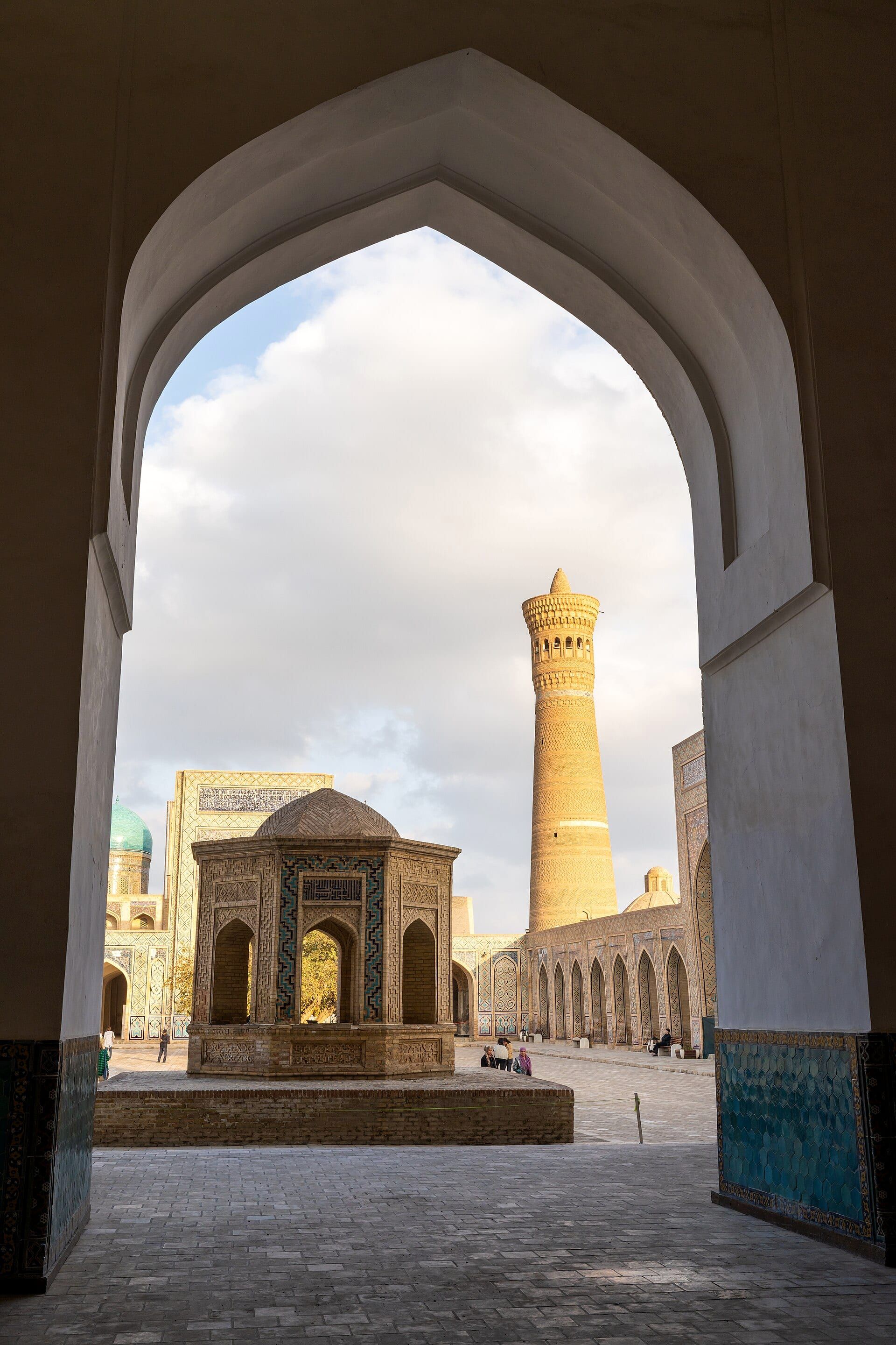 The Kalyan minaret in Bukhara rising above the Po-i-Kalyan square in afternoon light
