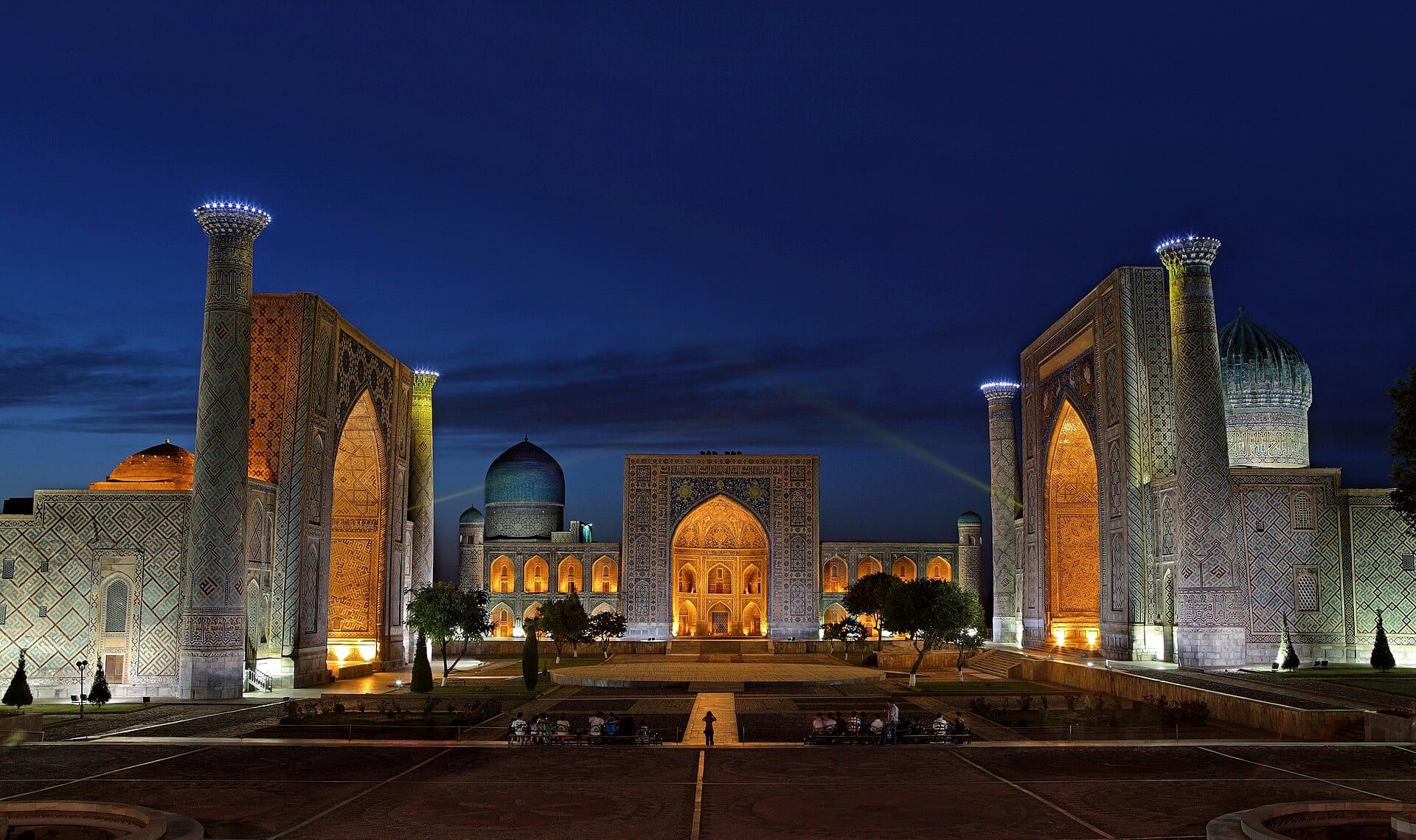 The three madrasas of the Registan in Samarkand at first light, the square still empty.