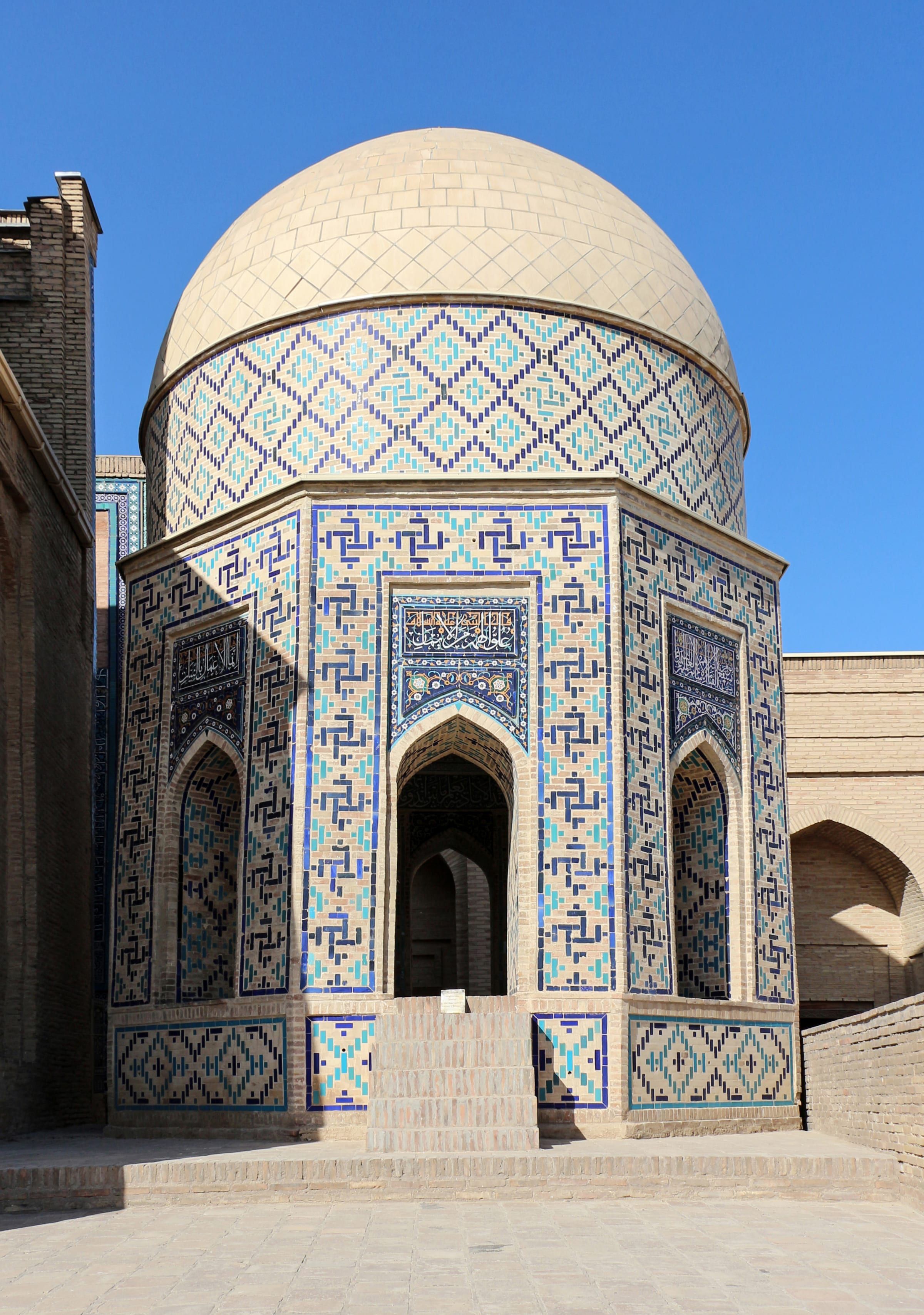 The tiled façades along the narrow stairway of the Shah-i-Zinda necropolis in Samarkand.